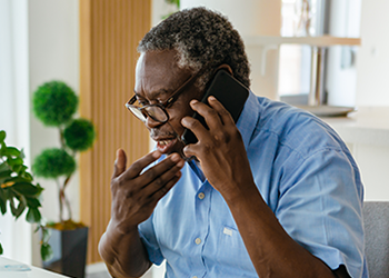 A man talking on the phone and looking concerned