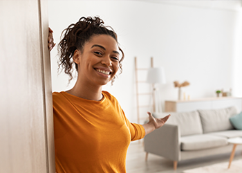 A young person welcoming the viewer into their home