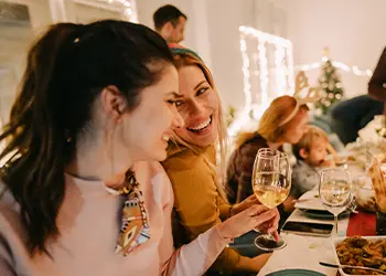 Two people laughing at a holiday dinner