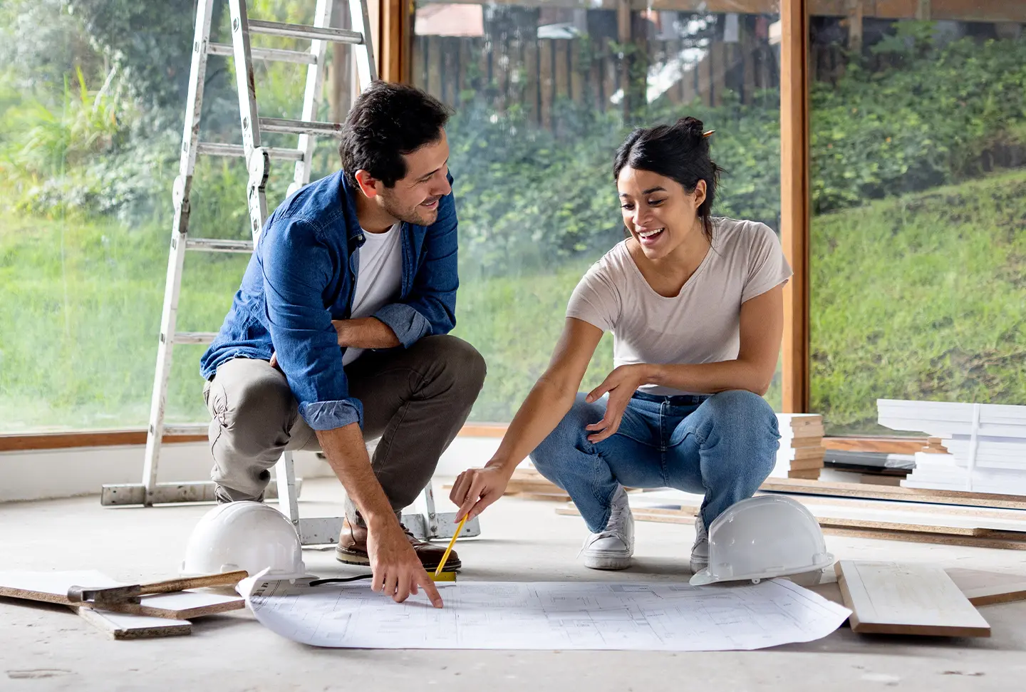 Two people looking at construction plans