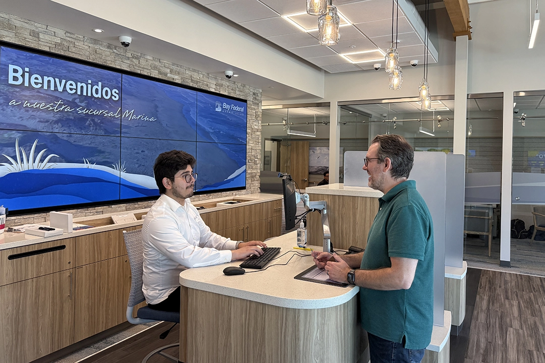 Happy member transacting with an MSR at Bay Federal