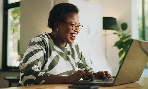 Woman smiling at her laptop