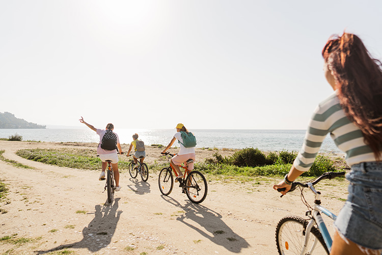 Family biking on the beach. 