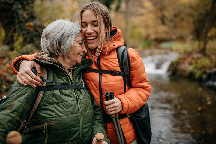 A woman with her arm around her elder.