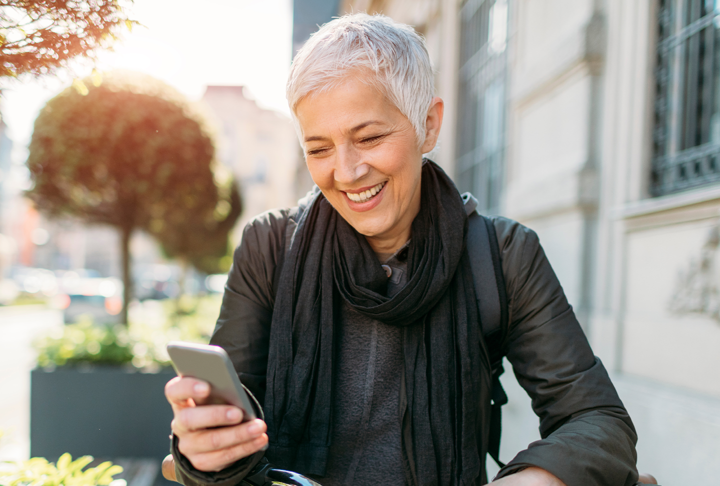 A woman on her bike looking at a phone